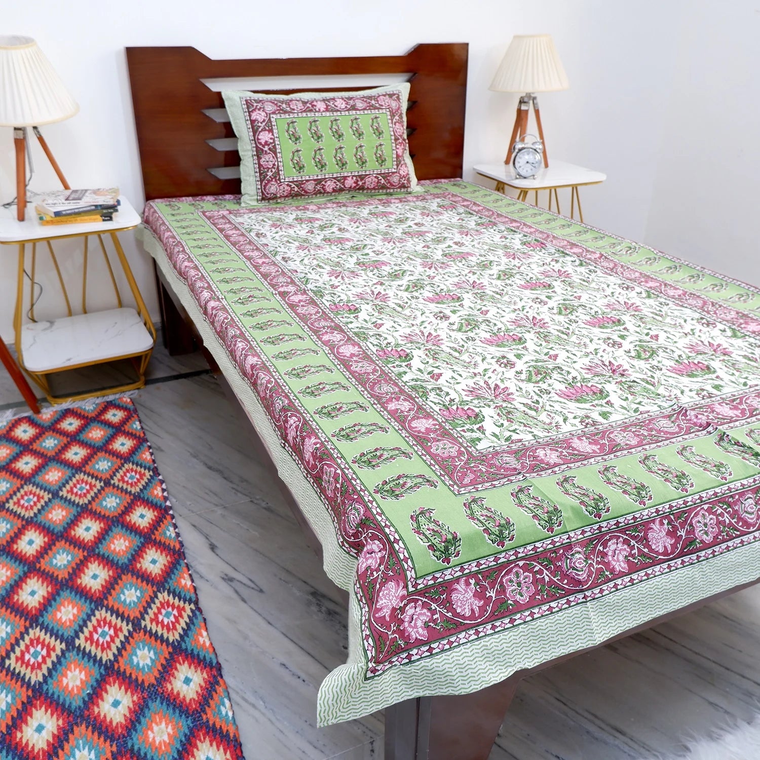 The Jaipuri pure cotton bed sheet online featuring floral patterns and vibrant colors on a well-made bed