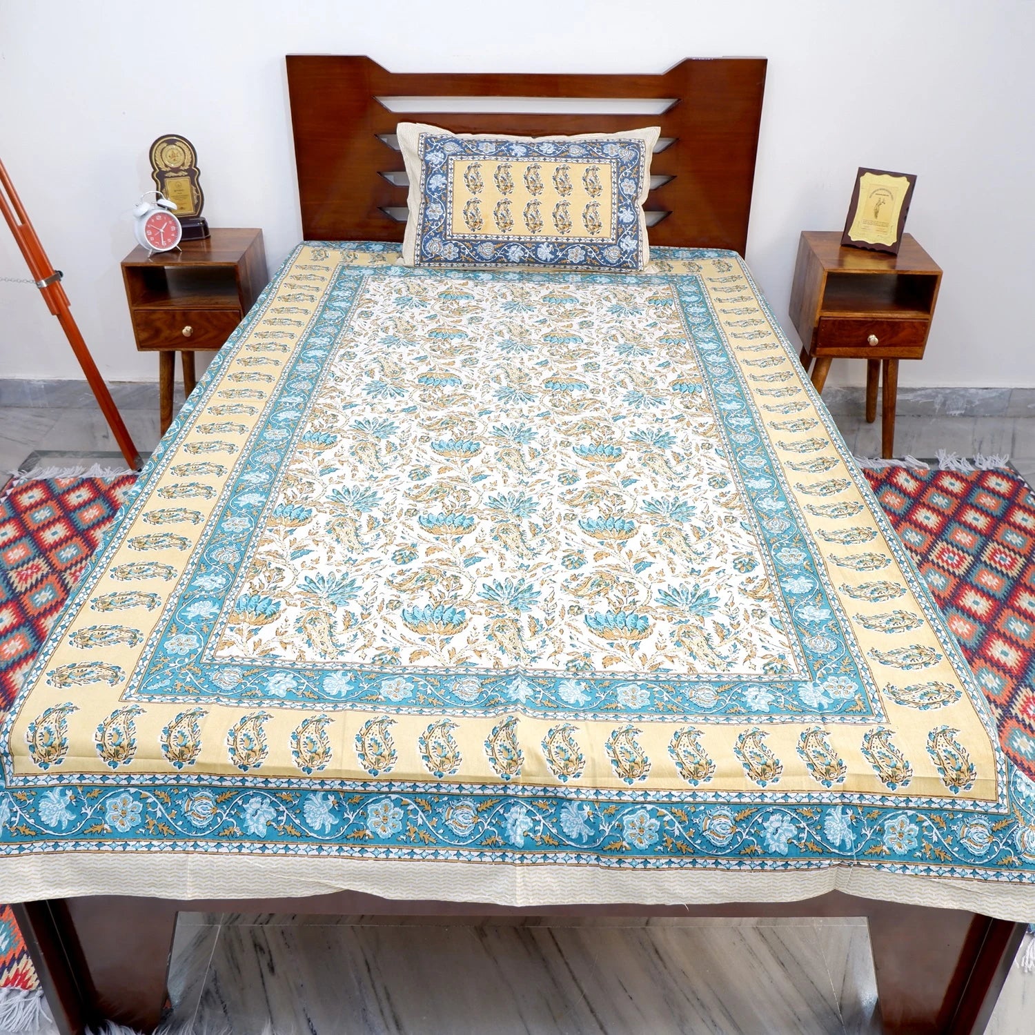 Elegant The Jaipuri pure cotton bed sheet online with floral design and matching pillow cover on a wooden bed
