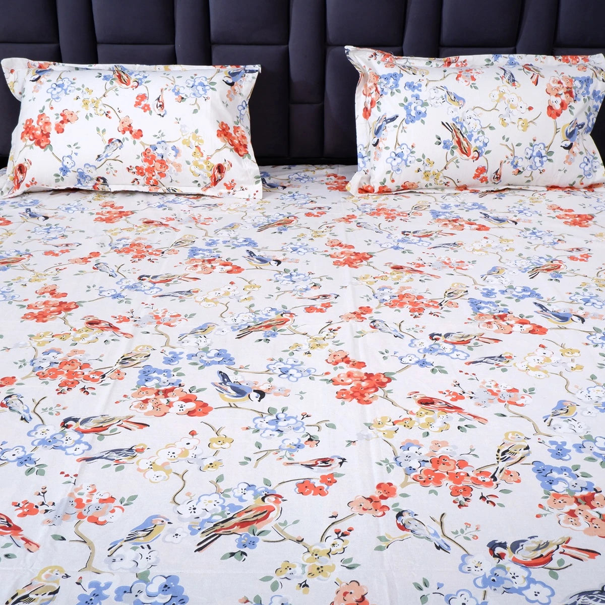 The Jaipuri pure cotton bed sheet with colorful floral and bird patterns for a vibrant bedroom decor